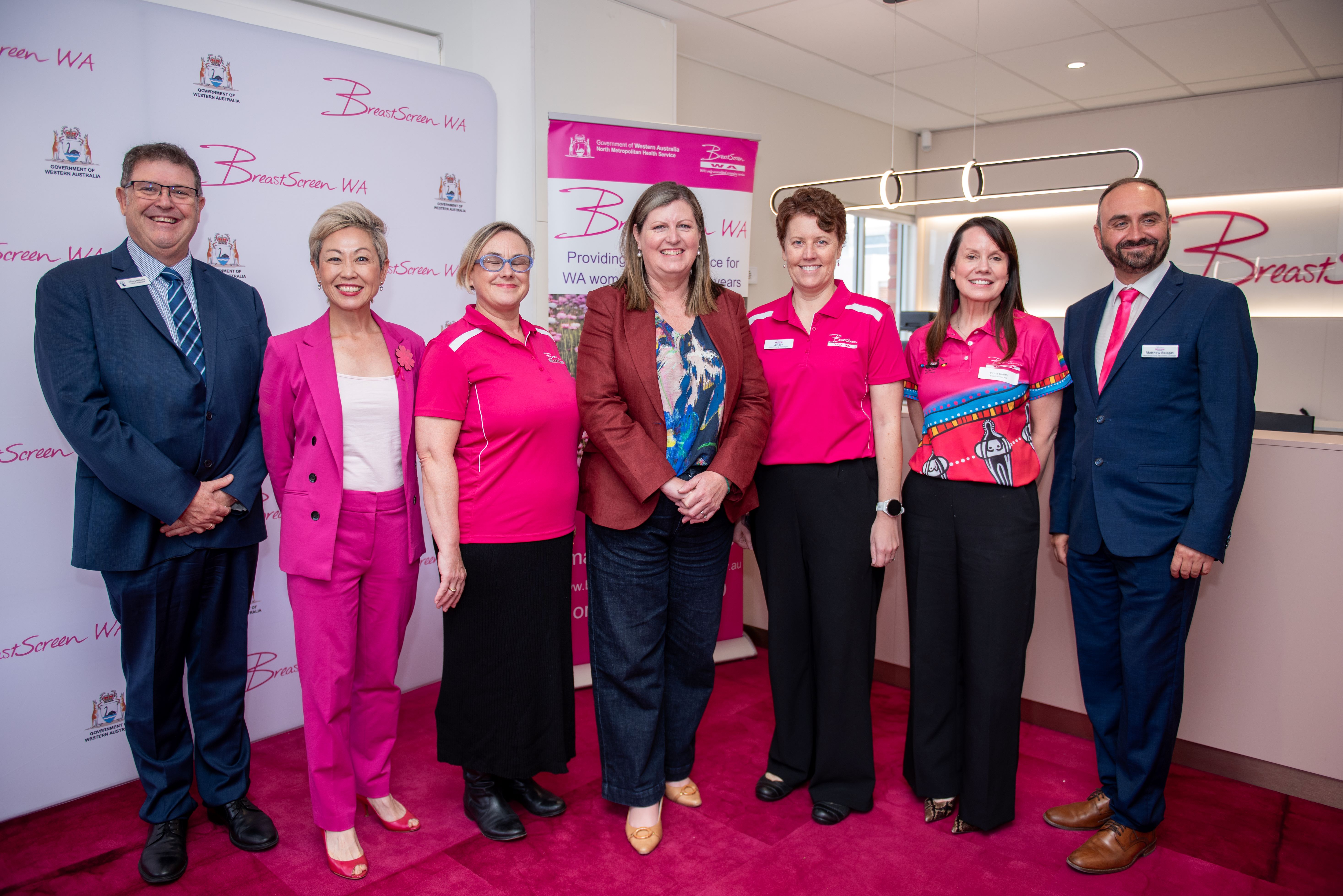 Group of people standing in a row and smiling at Bunbury clinic