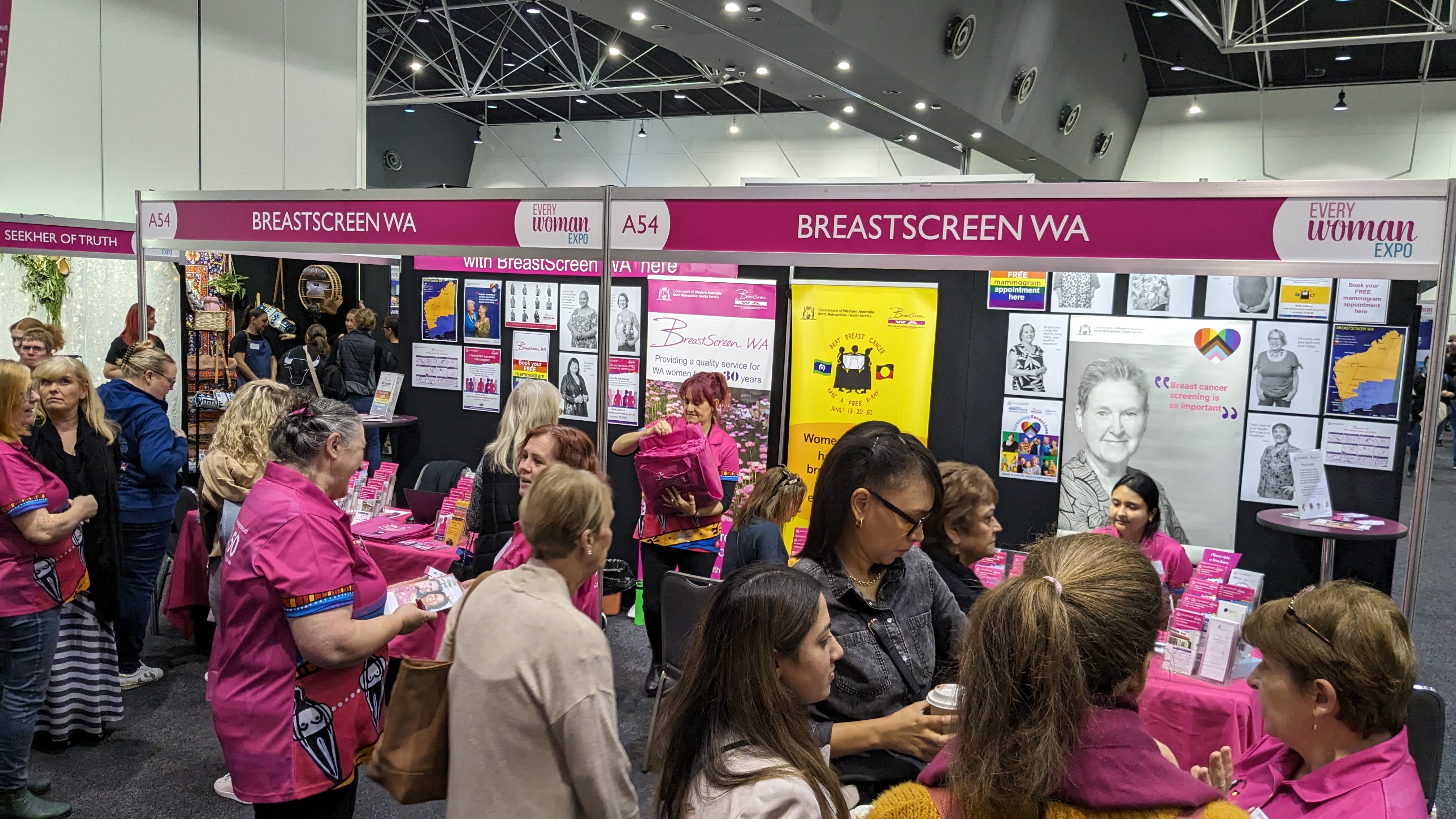 Staff and clients in front of BreastScreen WA display at EveryWoman Expo