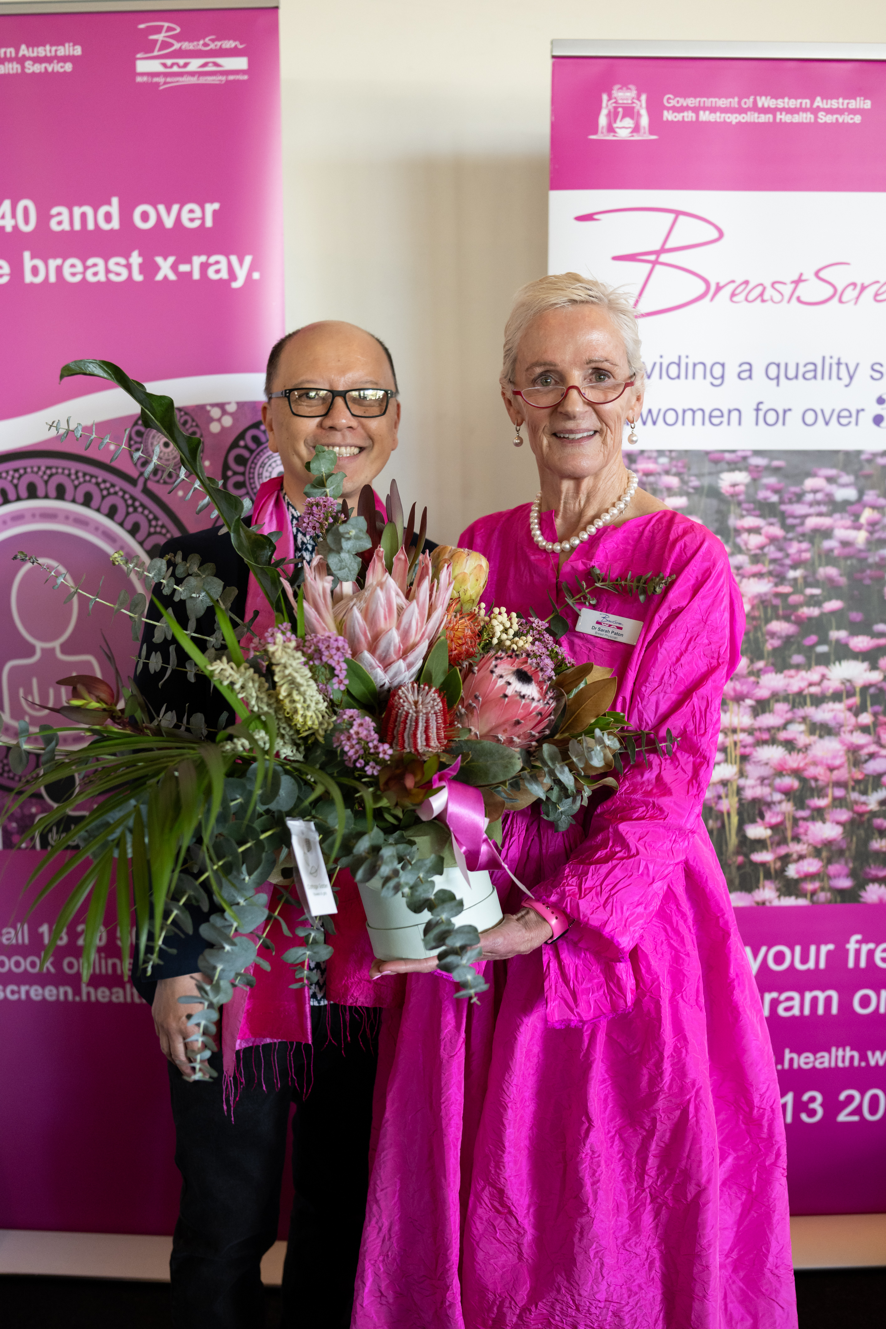 Guest speaker Dr Sarah Paton and GP Liaison Dr Eric Khong holding bouquet of flowers
