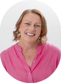 Jodie smiling at camera wearing pink top