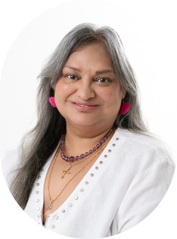 Melanie smiling at camera with white top