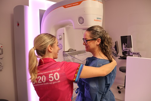 Mammographer screening a client