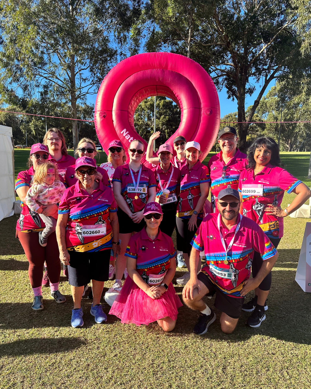Group photo of team at Mother's Day Classic fun run, all in matching pink shirts