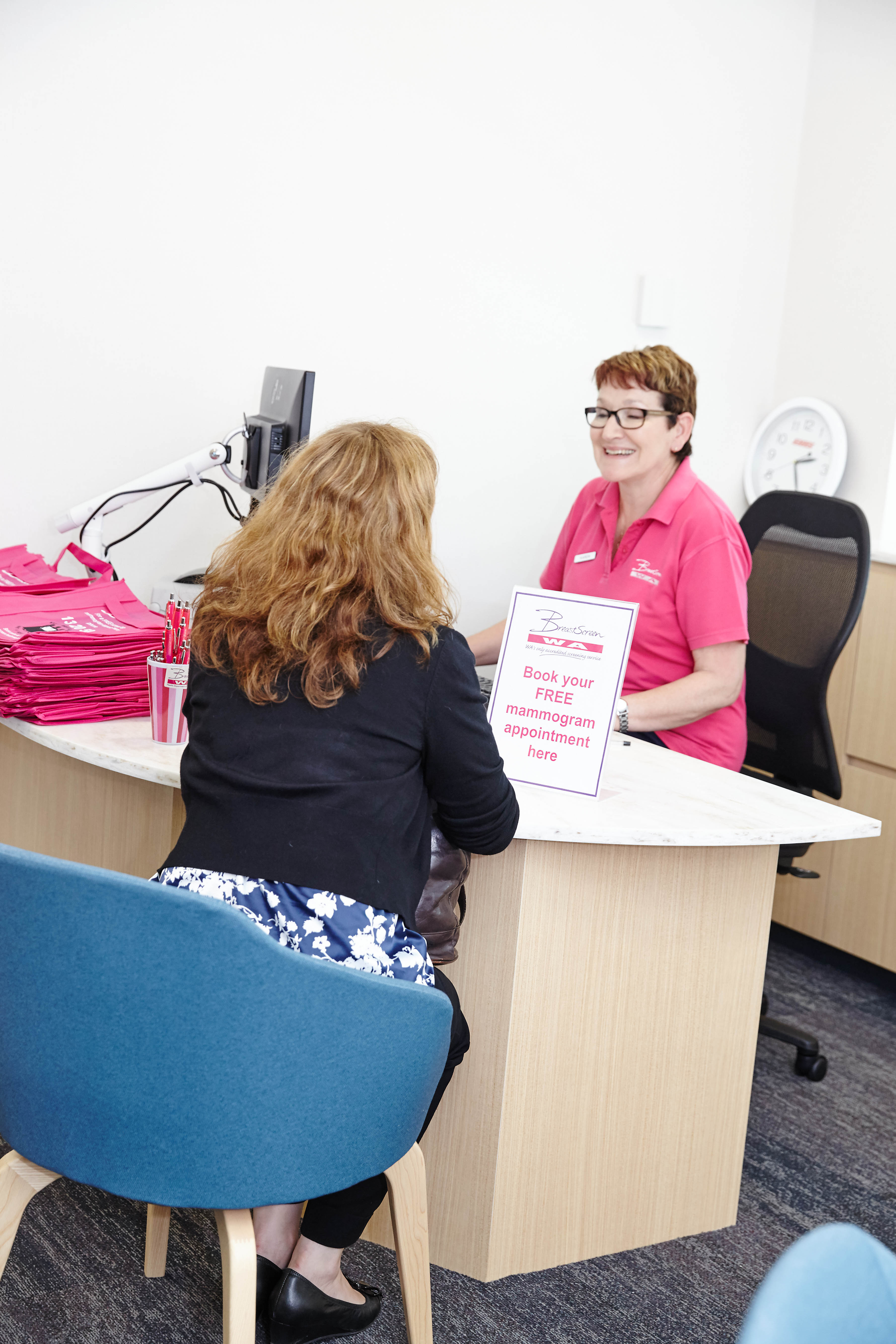 Client with receptionist in clinic