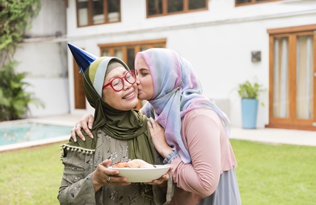 Two women in hijab at a party