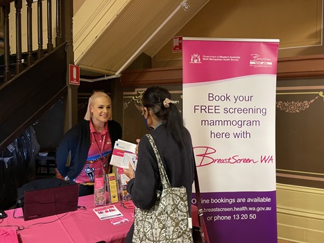 Staff member talking to person at event